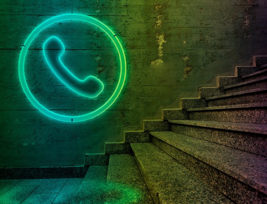 Telephone sign on concrete wall.