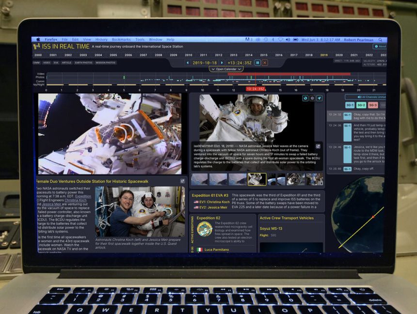 a laptop computer sitting on a mission control console displays a website