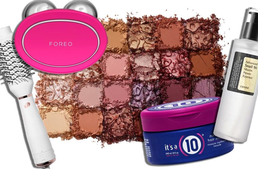 assortment of on-sale beauty products, including a round hair dryer brush and a serum, over an eyeshadow pigment background