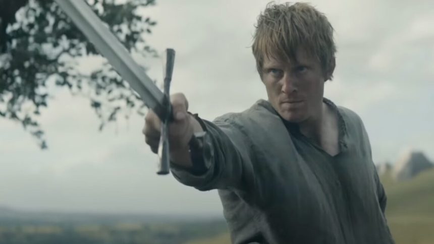 man in humble medieval shirt wielding a sword before an unseen enemy