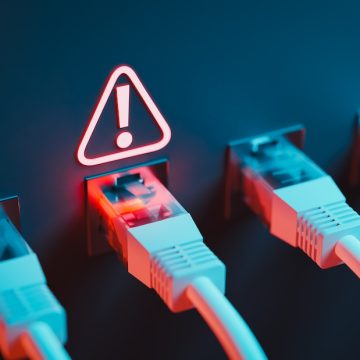 A single point of failure triggered the Amazon outage affecting Ethernet cables accompanies by an exclamation points inside a triangle.