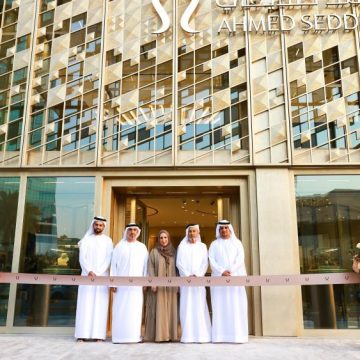 Ahmed Seddiqi family members stand at ribbon-cutting ceremony in front of new Riyadh flagship boutique with geometric patterned facade and brand signage