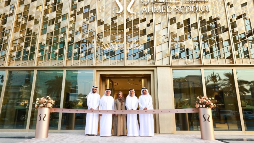Ahmed Seddiqi family members stand at ribbon-cutting ceremony in front of new Riyadh flagship boutique with geometric patterned facade and brand signage