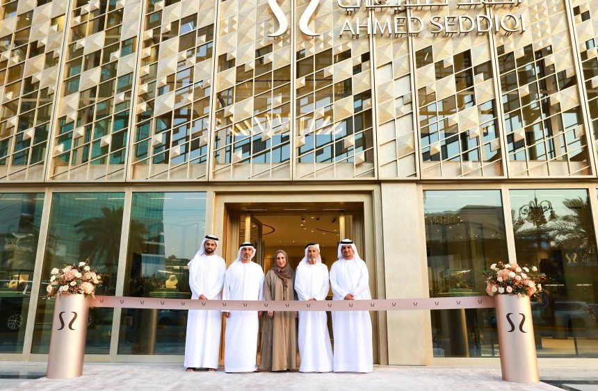 Ahmed Seddiqi family members stand at ribbon-cutting ceremony in front of new Riyadh flagship boutique with geometric patterned facade and brand signage