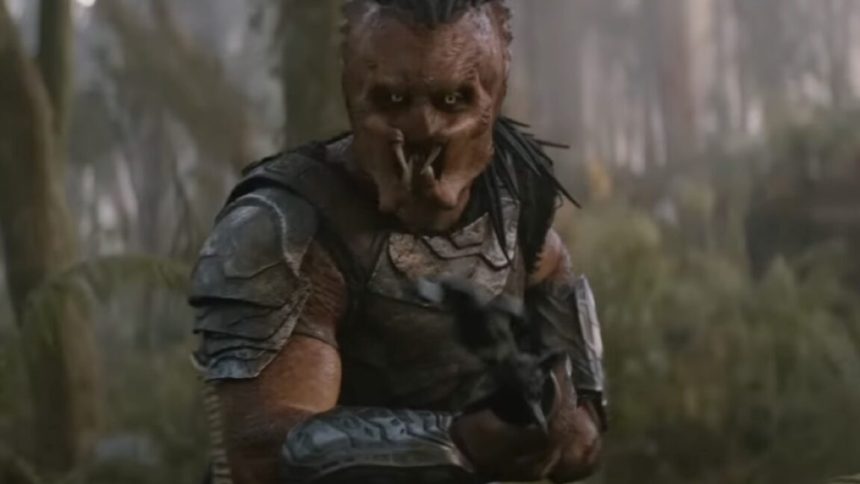 A Predator on an alien world brandishing a weapon