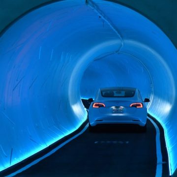 A Tesla car drives through a tunnel in the Central Station during a media preview of the Las Vegas Convention Center Loop on April 9, 2021 in Las Vegas, Nevada.