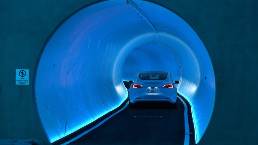 A Tesla car drives through a tunnel in the Central Station during a media preview of the Las Vegas Convention Center Loop on April 9, 2021 in Las Vegas, Nevada.
