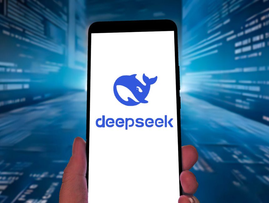 DeepSeek logo on a smartphone against a blue streaming-code tech-ish background.