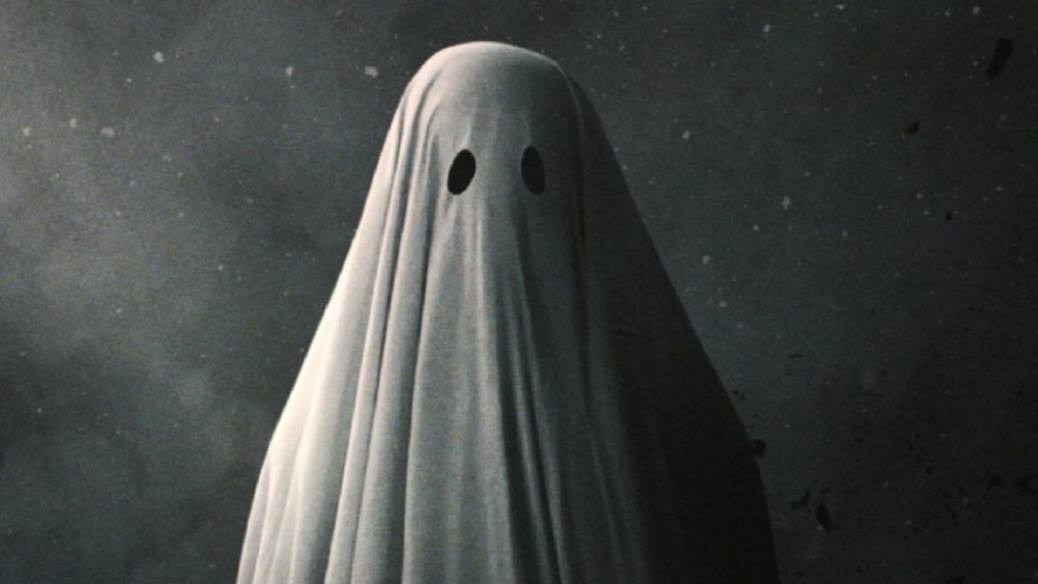 Poster art for 2017 film A Ghost Story featuring a figure draped in a white sheet with eye holes cut out