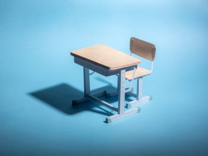 High school’s AI security system confuses Doritos bag for a Empty school desk on a blue background. .
