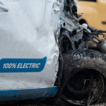 Crashed electric car in severe accident, frontal impact. Safety idea