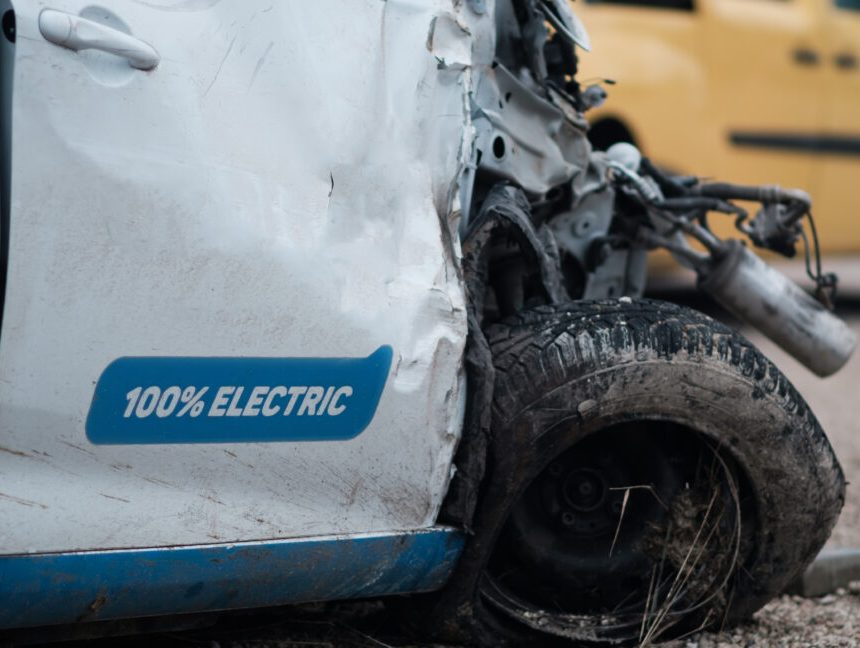 Crashed electric car in severe accident, frontal impact. Safety idea