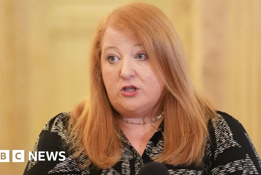 Justice minister condemns 'mob' outside home