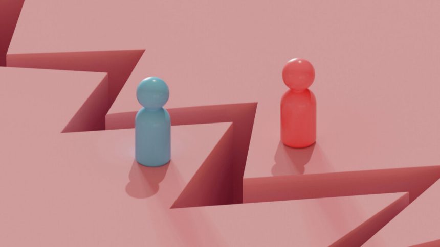 Two toy people figures separated by a crack in the ground.