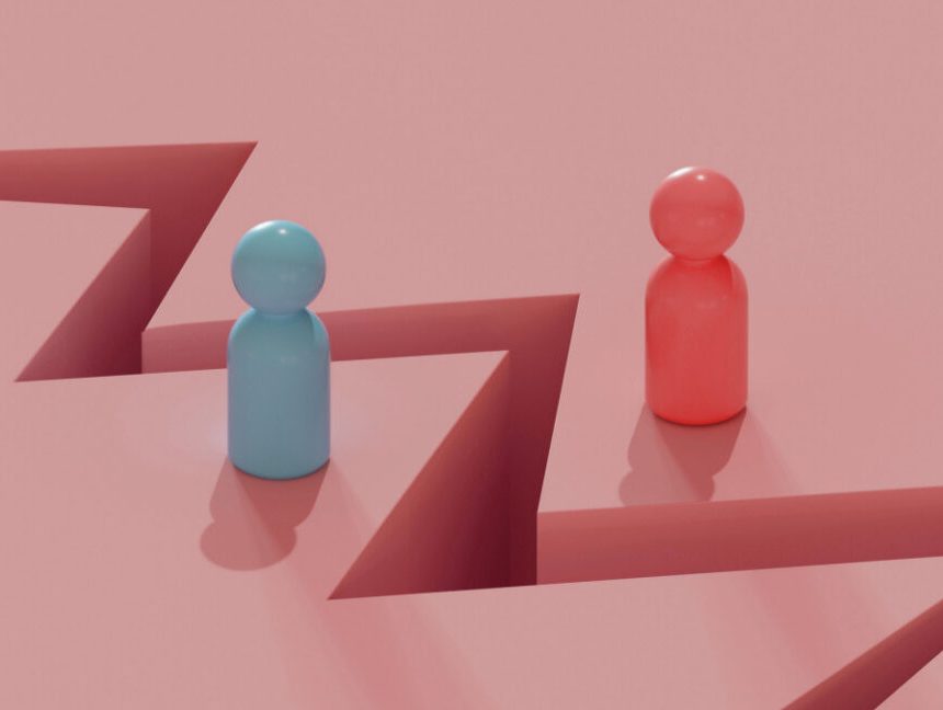 Two toy people figures separated by a crack in the ground.