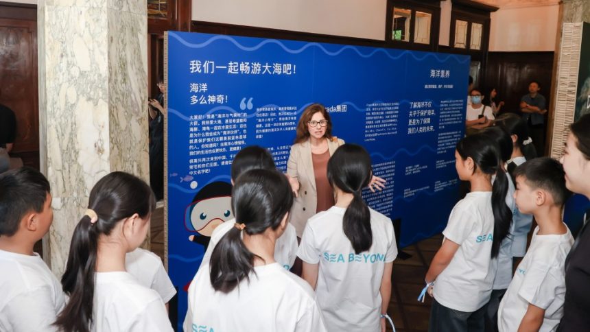 Francesca Santoro, IOC Senior Programme Officer with children from the inland Guizhou province, who have never seen the ocean, at the Prada Sea Beyond exhibition in Rong Zhai, Shanghai