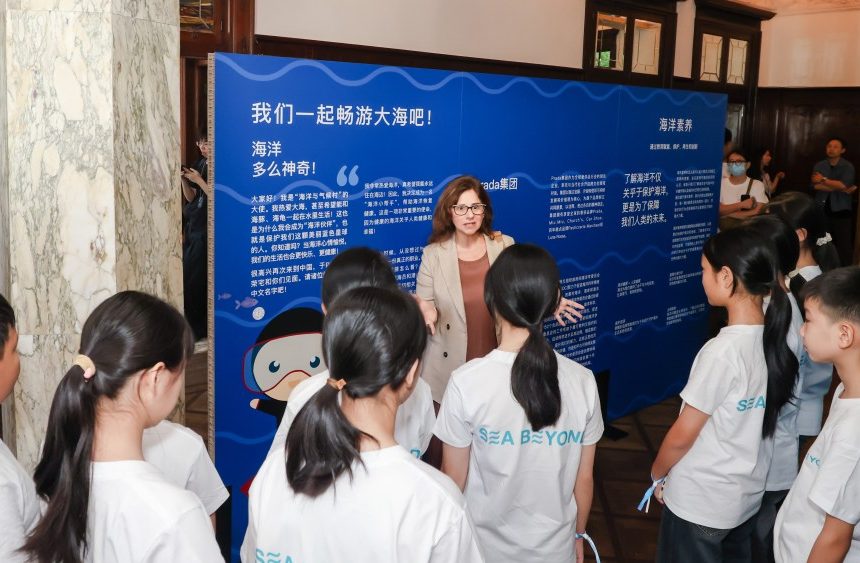 Francesca Santoro, IOC Senior Programme Officer with children from the inland Guizhou province, who have never seen the ocean, at the Prada Sea Beyond exhibition in Rong Zhai, Shanghai