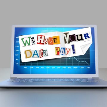 A ransom note is plastered across a laptop monitor.