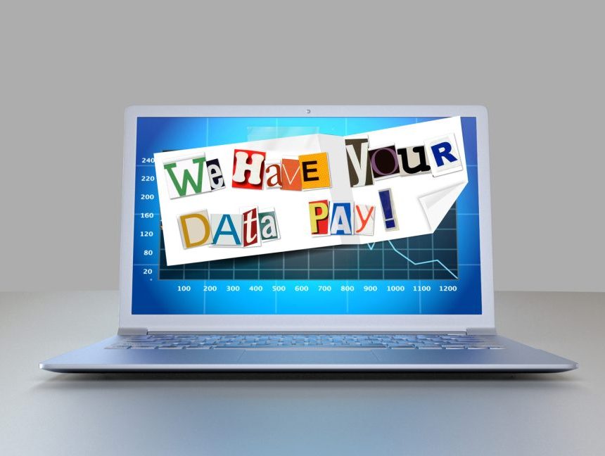 A ransom note is plastered across a laptop monitor.