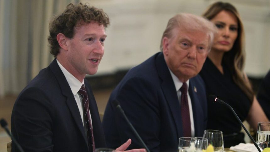 Mark Zuckerberg, Donald Trump, and Melania Trump sit next to each other at a table while Zuckerberg speaks into a microphone.