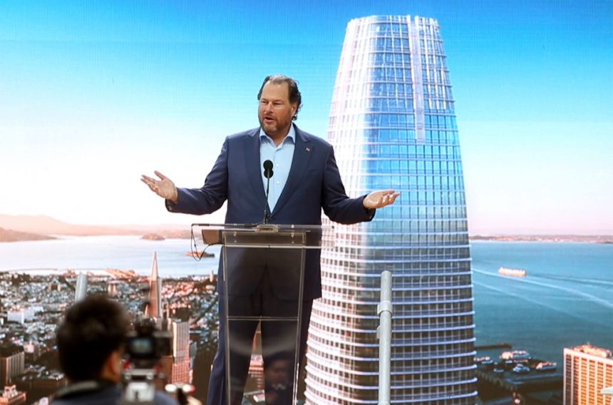 Trump credits Benioff, Huang for decision not to ‘surge’ Fed Marc Benioff standing at a podium in front of a backdrop of Salesforce Tower.