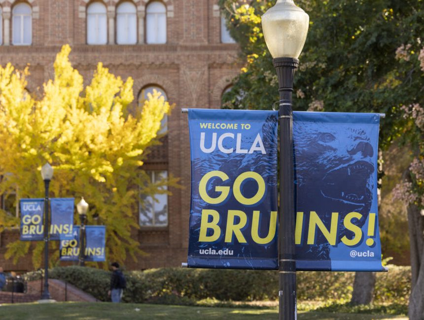 Image of a UCLA banner in front of brick buildings on a campus.