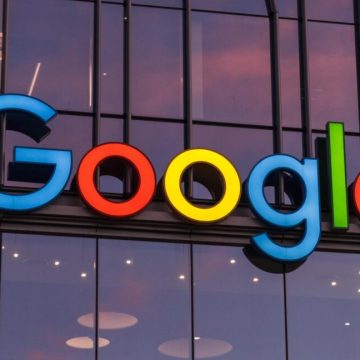 A large Google logo on the outside of a company building.