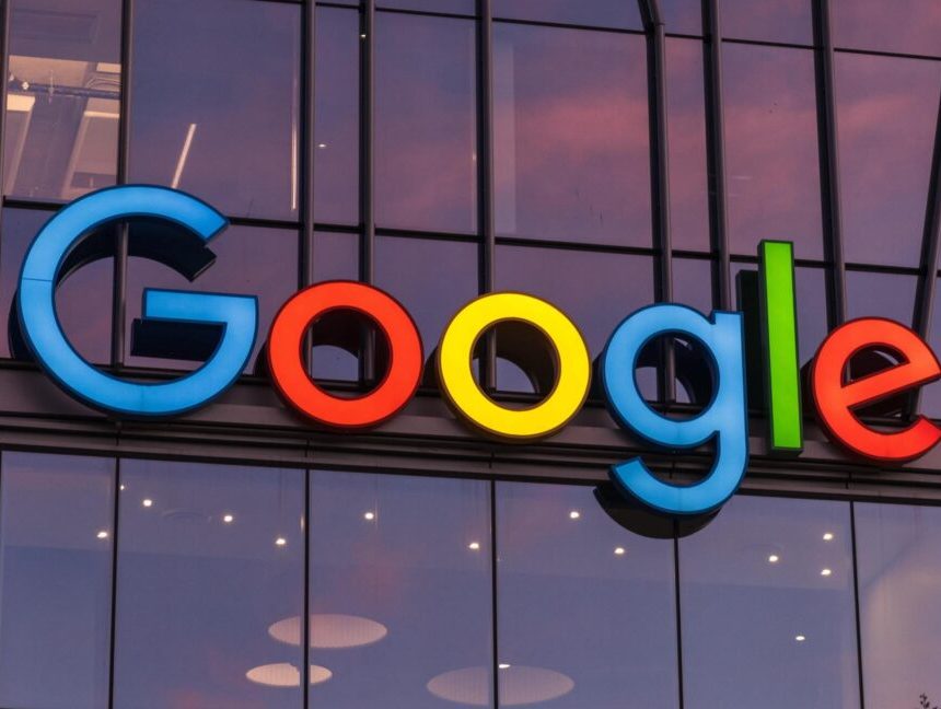 A large Google logo on the outside of a company building.