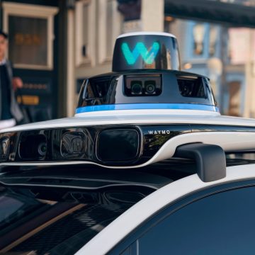 A close up of the rooftop of a Waymo robotaxi that shows sensors.