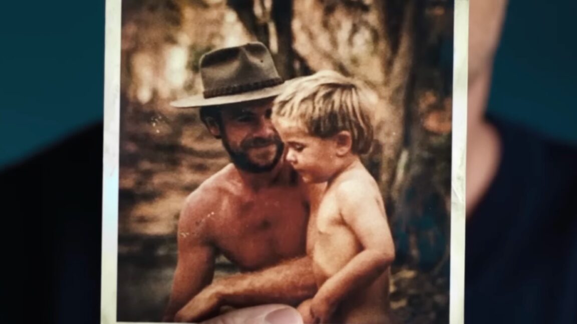 old photograph of man in a bush hat holding young son in the Australian outback
