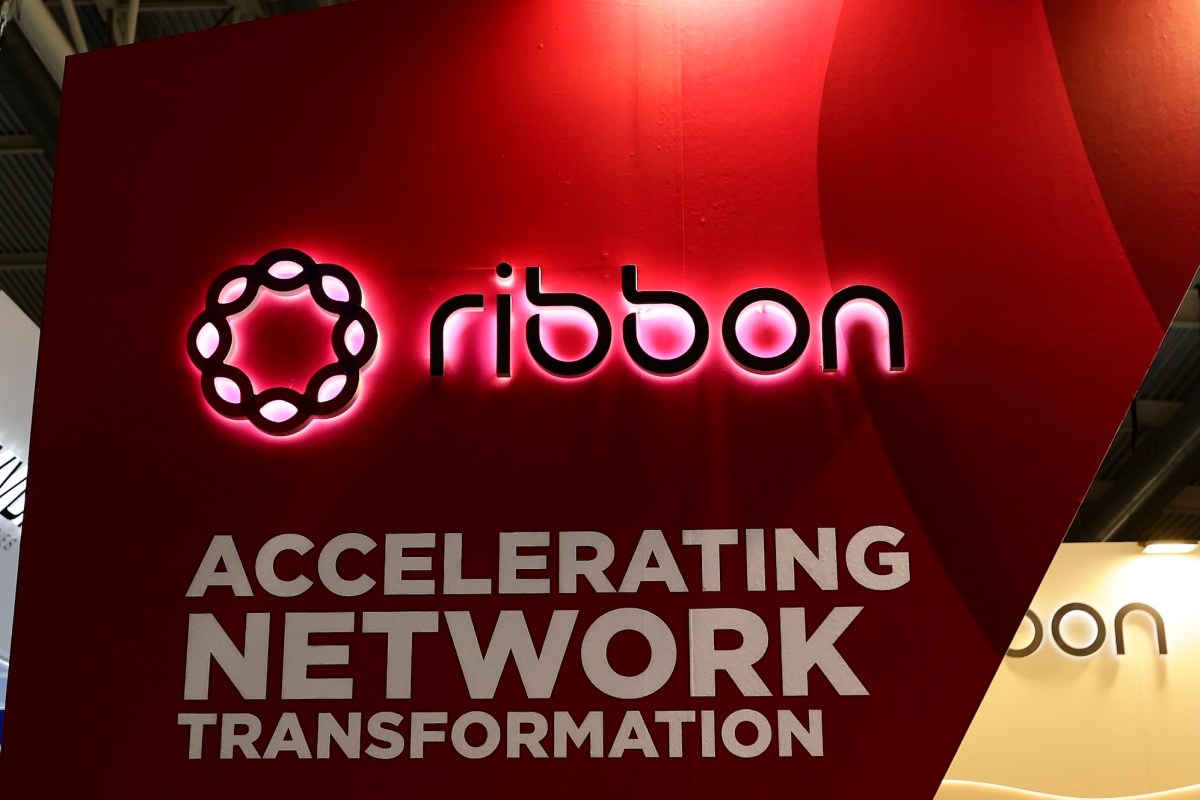 a photo showing Ribbon Communicatons' signage on a red background