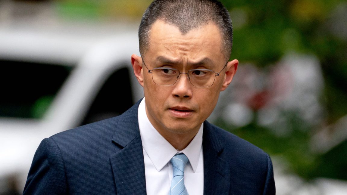 Former Binance CEO Changpeng Zhao walking outside a court house.