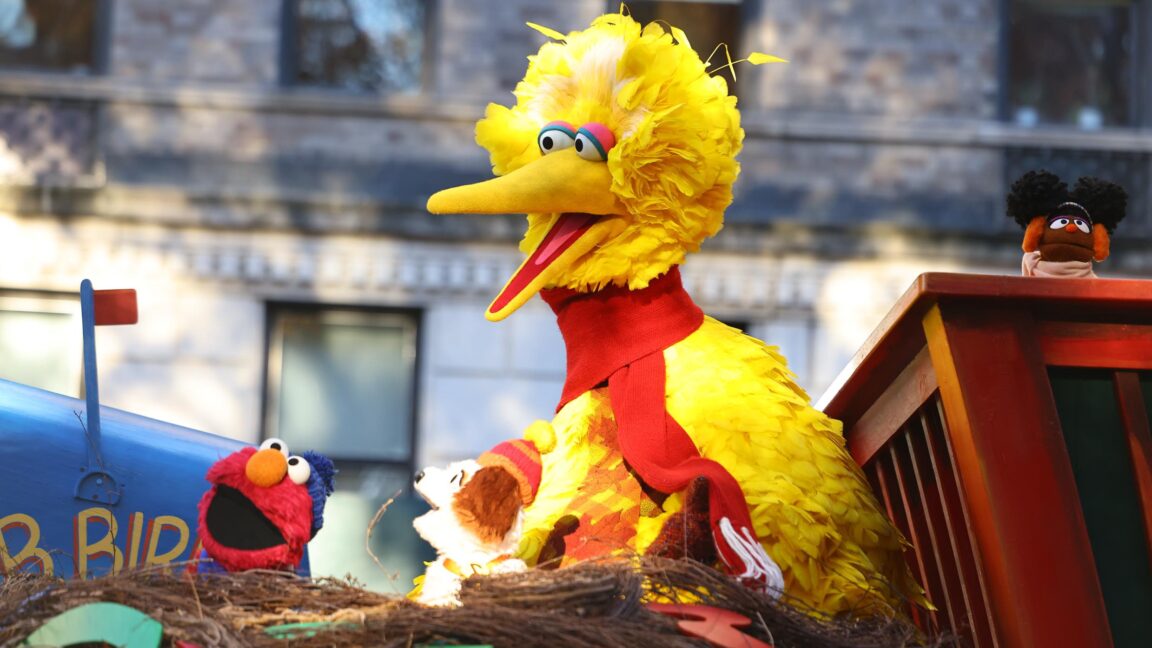 Sesame Street characters Big Bird and Elmo on a float during a Thanksgiving Day parade.