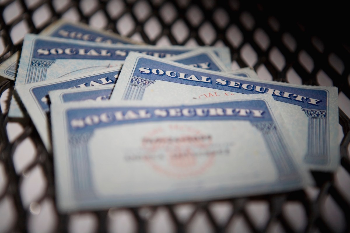 a close up shot of several Social Security cards on a chequered mat.
