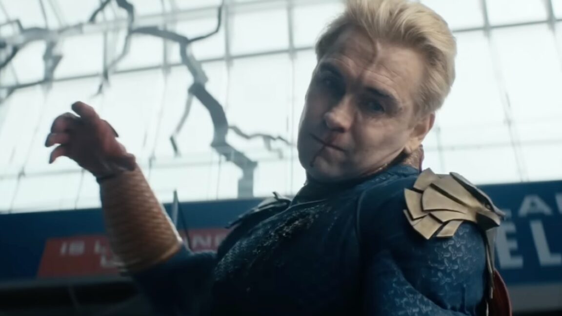 homeland with blood spattered face and raised fist about to rain down blows on an unseen opponent.